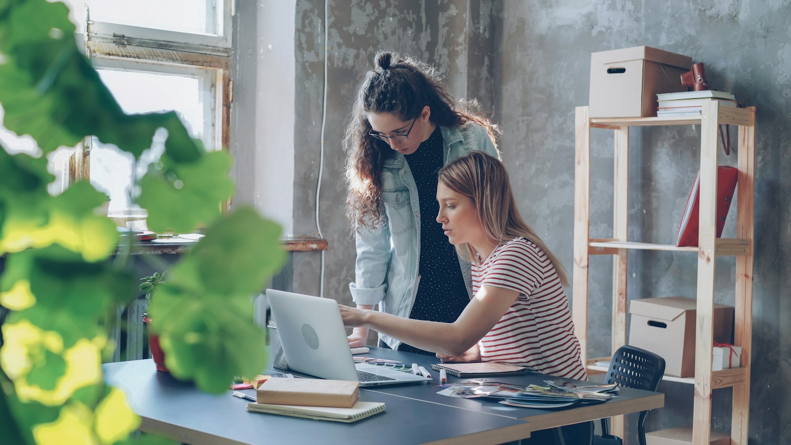 Design team collaborating around a laptop