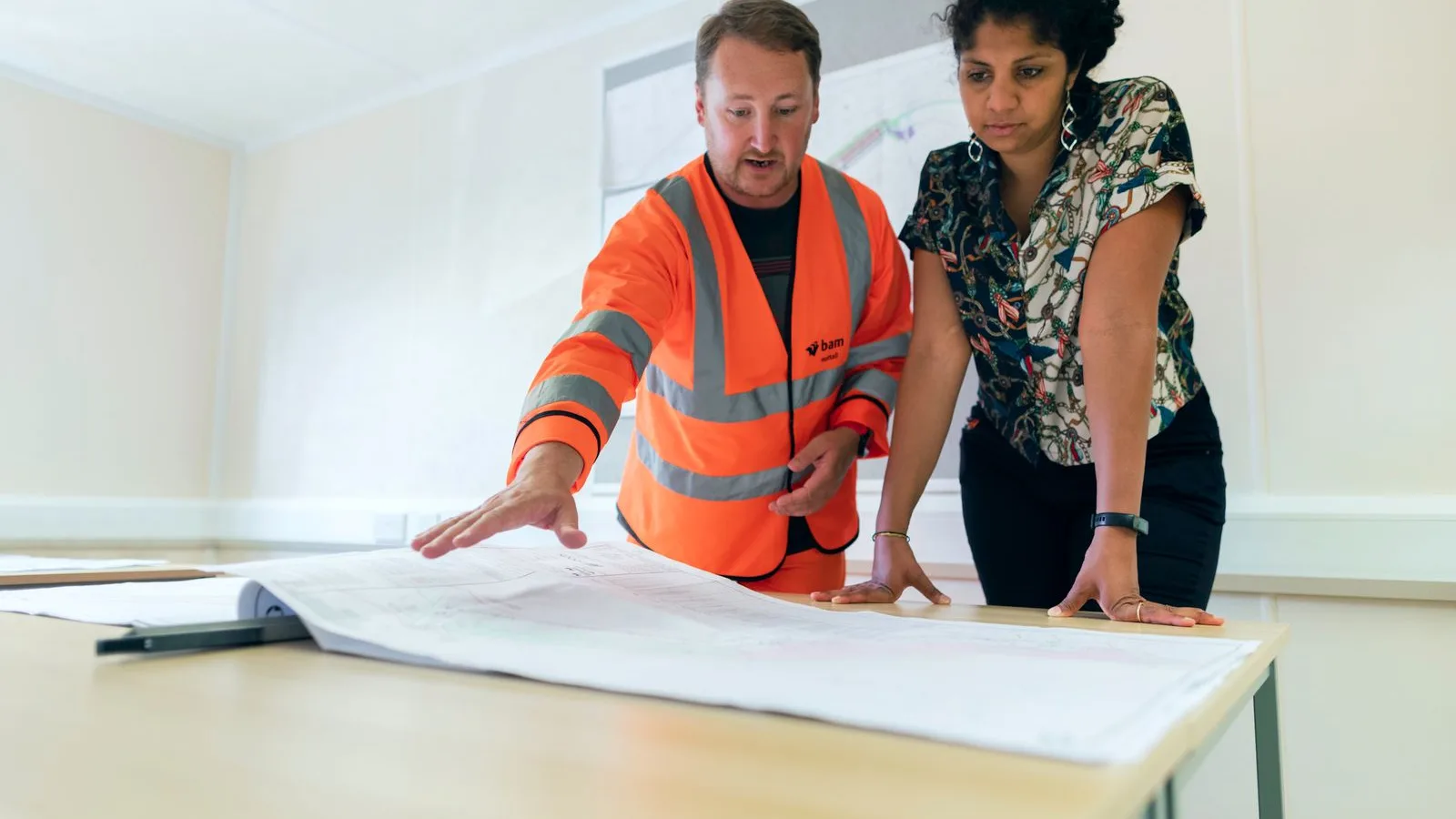 Engineers reviewing technical project drawings
